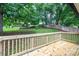 Open wood deck overlooking a large, grassy, fenced backyard with mature trees and landscaping at 1309 Poplar Cir, Newton, NC 28658