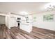 Updated kitchen featuring white cabinets, a center island, stainless steel appliances, and wood flooring at 1309 Poplar Cir, Newton, NC 28658