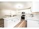 Bright kitchen with white cabinetry, stainless steel appliances, an island, and modern pendant lighting at 1309 Poplar Cir, Newton, NC 28658