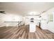 Open-concept living room with white walls, wood floors, and a modern kitchen in the background at 1309 Poplar Cir, Newton, NC 28658