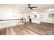 Open floorplan with updated flooring, white walls, modern lighting, and a glimpse of the updated kitchen at 1309 Poplar Cir, Newton, NC 28658
