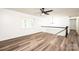 Spacious living room showcasing wood floors, white walls, a window, and a modern fan at 1309 Poplar Cir, Newton, NC 28658