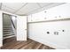 A storage area in the basement featuring luxury vinyl plank flooring and a staircase at 1309 Poplar Cir, Newton, NC 28658