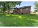 The backyard boasts a covered deck, verdant lawn, and classic brick architecture at 1622 Brookstone Dr, Hickory, NC 28602