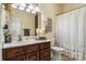 Bathroom featuring a dark wood vanity, bright lighting, and neutral decor at 1622 Brookstone Dr, Hickory, NC 28602