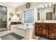 Bathroom featuring double sinks, soaking tub, and natural light at 1622 Brookstone Dr, Hickory, NC 28602