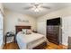 Comfortable bedroom featuring a ceiling fan, wood floors, and dark wood furnishings at 1622 Brookstone Dr, Hickory, NC 28602