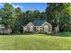 Charming brick home featuring a well-manicured lawn, mature trees, and welcoming curb appeal at 1622 Brookstone Dr, Hickory, NC 28602