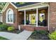 Inviting front porch with comfortable seating, decorative plants, and charming curb appeal at 1622 Brookstone Dr, Hickory, NC 28602