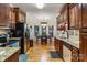 Modern kitchen with wooden cabinets, granite countertops, stainless steel appliances, and an adjacent dining area at 1622 Brookstone Dr, Hickory, NC 28602