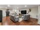 Finished basement with comfortable seating, tv, and wood laminate floors at 1622 Brookstone Dr, Hickory, NC 28602