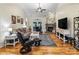 Bright living room featuring hardwood floors, a stone fireplace, and comfortable seating at 1622 Brookstone Dr, Hickory, NC 28602