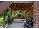 Cozy covered patio features string lights, ceiling fan, and outdoor seating area with a grill at 1622 Brookstone Dr, Hickory, NC 28602