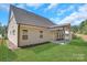 A backyard featuring a well-maintained lawn and covered patio perfect for relaxing or entertaining at 1630 Riddle Ext, Clover, SC 29710