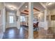 Inviting entryway with beautiful hardwood floors, wood beams and trim, leading into the dining room at 1630 Riddle Ext, Clover, SC 29710