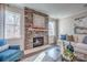 Cozy living room features a stone fireplace, plush seating, and plenty of natural light at 1630 Riddle Ext, Clover, SC 29710