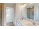 Bathroom featuring double sink vanity, a walk-in shower, and natural light at 1821 Augustine St, Monroe, NC 28112