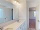 Bright bathroom featuring a double vanity, white cabinetry, and a large mirror with modern lighting at 1821 Augustine St, Monroe, NC 28112