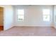 Bedroom featuring neutral carpet, large windows, and a bright, airy feel at 1821 Augustine St, Monroe, NC 28112