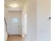 Bright entryway featuring hardwood floors, neutral walls, and a white front door with glass panes at 1821 Augustine St, Monroe, NC 28112