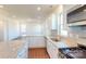 Open-concept kitchen with granite counters, a gas range, stainless appliances, and bright lighting at 1821 Augustine St, Monroe, NC 28112