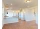 Open-concept living space with hardwood floors and a seamlessly connected kitchen at 1821 Augustine St, Monroe, NC 28112