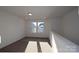 Open loft area featuring plush carpeting, bright natural light, and white trim at 1821 Augustine St, Monroe, NC 28112