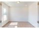 A well-lit office with wood floors, white walls, and a large window offering natural light at 1821 Augustine St, Monroe, NC 28112