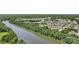 Aerial view of a community by a river, highlighting residential homes and lush greenery at 2052 Masons Bend Dr, Fort Mill, SC 29708