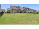 View of the fenced backyard with green grass and a view of the house featuring a screened-in porch at 2052 Masons Bend Dr, Fort Mill, SC 29708