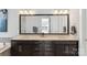 Bathroom featuring a double vanity with dark cabinets, white countertops, and a large mirror reflecting the shower and toilet at 2052 Masons Bend Dr, Fort Mill, SC 29708