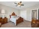 Spacious bedroom featuring a ceiling fan, neutral paint and carpet, closet, and wooden furniture at 2052 Masons Bend Dr, Fort Mill, SC 29708
