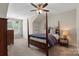 Comfortable bedroom featuring a four-poster bed, neutral walls, a ceiling fan, and natural light from the window at 2052 Masons Bend Dr, Fort Mill, SC 29708