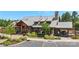 View of the clubhouse and landscaping, showcasing a metal roof, stone exterior, timber beams and parking at 2052 Masons Bend Dr, Fort Mill, SC 29708