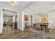 Elegant dining room with hardwood floors, a stylish chandelier, and open access to a living space at 2052 Masons Bend Dr, Fort Mill, SC 29708