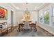 Bright dining area features a modern chandelier, tray ceilings, and large windows bringing in natural light at 2052 Masons Bend Dr, Fort Mill, SC 29708