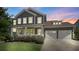 Beautiful two-story home with a two-car garage, a charming front porch, and manicured landscaping at twilight at 2052 Masons Bend Dr, Fort Mill, SC 29708
