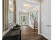 Inviting foyer featuring hardwood floors, a staircase, and natural light streaming through the glass front door at 2052 Masons Bend Dr, Fort Mill, SC 29708
