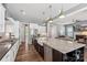 Modern kitchen open to living room, featuring an island with seating, and stainless steel appliances at 2052 Masons Bend Dr, Fort Mill, SC 29708