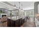 Eat-in kitchen featuring a large island with sink, stainless steel appliances, and an adjacent dining area at 2052 Masons Bend Dr, Fort Mill, SC 29708