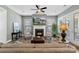 Inviting living room featuring a fireplace, a comfortable sofa, and natural light from the large windows at 2052 Masons Bend Dr, Fort Mill, SC 29708