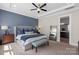 Large main bedroom featuring carpet floors, a tray ceiling, ensuite bath, and a full-length mirror at 2052 Masons Bend Dr, Fort Mill, SC 29708