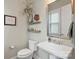 Stylish powder room featuring a modern sink, decorative shelves, and a decorative mirror at 2052 Masons Bend Dr, Fort Mill, SC 29708