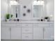 Stylish double sink vanity area in bathroom featuring modern fixtures, two mirrors, and decor at 2148 Nims Village Dr, Fort Mill, SC 29715