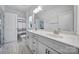 Light bathroom with a double vanity, granite countertops, a window, and tiled floors at 2148 Nims Village Dr, Fort Mill, SC 29715