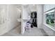 Walk-in closet with custom shelving, clothing racks, and window with exterior view at 2148 Nims Village Dr, Fort Mill, SC 29715