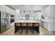 Modern kitchen features an island with seating, stainless steel appliances, and stylish backsplash at 2148 Nims Village Dr, Fort Mill, SC 29715