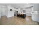 Bright, open kitchen featuring a large center island, stainless steel appliances, and sleek white cabinetry at 2148 Nims Village Dr, Fort Mill, SC 29715