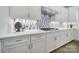 Elegant kitchen with white cabinets, quartz countertops, stainless steel appliances, and a decorative backsplash at 2148 Nims Village Dr, Fort Mill, SC 29715