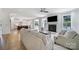 Spacious living room with a fireplace and large windows, seamlessly connected to a modern kitchen at 2148 Nims Village Dr, Fort Mill, SC 29715